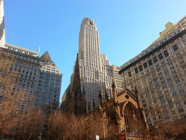 View of 1 Wall Street with Trinity Church in Foreground